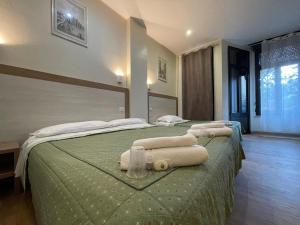 a hotel room with a bed with towels on it at Hotel 26 in Milan