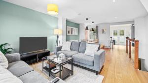 a living room with a couch and a tv at Cotswold Road North in Bristol