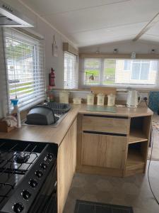 a kitchen with a stove and a counter top at Dave and Deb's Place Beverley Bay in Paignton