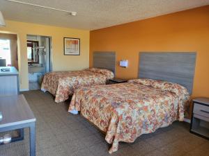 Postel nebo postele na pokoji v ubytování Royal Inn