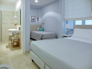 Postel nebo postele na pokoji v ubytování L'OSPITE - LIFESTYLE RESIDENCE, Design Rooms + 125 fotografií