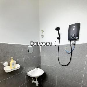a bathroom with a shower with a sink and a toilet at CASARIA HOMESTAY PD 3Bedrooms Bungalow House in Port Dickson