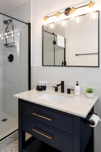 a bathroom with a sink and a mirror at * Affordable Luxury Park Circle, Tres Chic! * in Charleston
