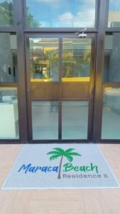 una puerta con un cartel de residencia en la playa enmarañada delante de ella en Maracaipe, um paraíso para você - Maraca Beach Residence II - ap 111, en Ipojuca