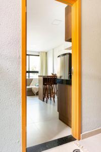 a view of a kitchen and a dining room at Maracaipe, um paraíso para você - Maraca Beach Residence II - ap 111 in Ipojuca