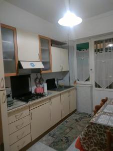 a kitchen with white cabinets and a counter top at B&B Stadio in Catanzaro
