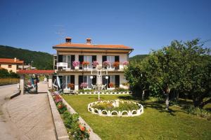 a house with a garden in front of it at Guesthouse Rutar in Rupa