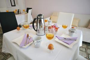 a white table with glasses of wine on it at Guesthouse Rutar in Rupa