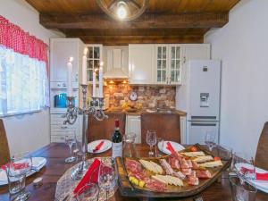 a kitchen with a table with a tray of food at Villa Sound of Silence in Poljica Kozička