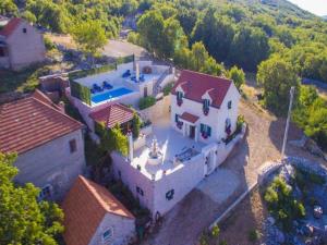 an aerial view of a house with a swimming pool at Villa Sound of Silence in Poljica Kozička