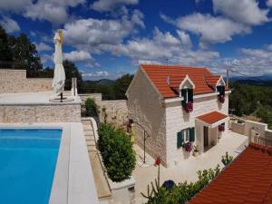 a villa with a swimming pool and a house at Villa Sound of Silence in Poljica Kozička
