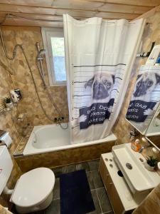 a bathroom with a tub and a dog shower curtain at Private Room in an old Farmhouse near Vaduz in Sevelen