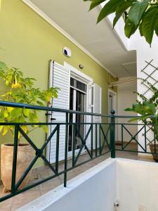 a balcony with a black railing and plants at Dimitris place near Athens airport in Koropíon