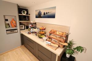 a kitchen with a counter with bread and food on it at Le Lotus Blanc in Albertville