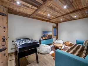 a room with a bunk bed and a couch at Chalet avec jacuzzi, proche des pistes, pour 10 personnes - FR-1-570-20 in Saint-Martin-de-Belleville