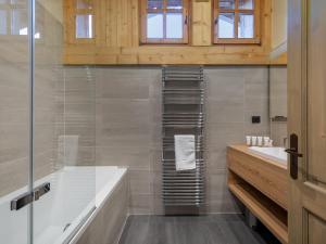 a bathroom with a tub and a glass shower at Chalet avec jacuzzi, proche des pistes, pour 10 personnes - FR-1-570-20 in Saint-Martin-de-Belleville