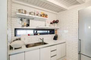 a kitchen with a sink and white walls at Hongdae 4bed room House in Seoul