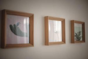 three picture frames on a wall with a cactus at Hongdae 4bed room House in Seoul