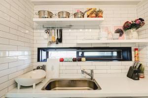 a kitchen with a sink and a window and a sink at Hongdae 4bed room House in Seoul