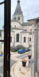 a view from a window of a building with a church at Au fil des étoiles in Selles-sur-Cher