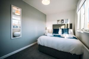 a bedroom with a large bed and a window at Freda House By Horizon Stays in Sunderland