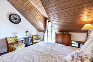 a bedroom with a large bed and a clock on the wall at Rusne Villa in Rusnė