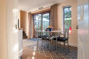 una sala da pranzo con tavolo e sedie su un tappeto di Terlingham Lane Cottage a Folkestone