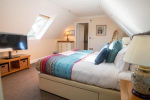 una camera da letto con un letto con una tv e una finestra di Terlingham Lane Cottage a Folkestone