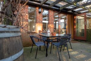 a table and chairs sitting on a patio at Terlingham Lane Cottage in Folkestone