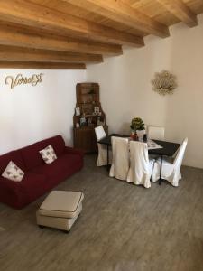 a living room with a red couch and a table at Verso Est in Petralia Soprana