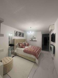 a bedroom with a bed and a chair in it at Appartement luxury in Montpellier