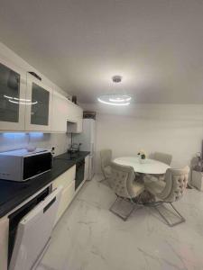 a kitchen with a table and chairs in a room at Appartement luxury in Montpellier