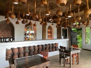 a bar with a table and lots of pots and pans at Mabamba Lodge in Wakiso