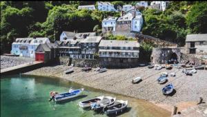 a group of boats on the shore of a body of water at Lundy Lookout 5 minutes drive to beach Hot tub in Westward Ho