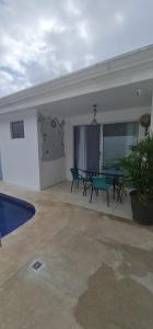 un patio con mesa y sillas junto a una piscina en Casa Vacacional en Herradura con piscina privada en Herradura