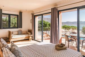 a bedroom with a bed and a view of the ocean at Imsouane Surf Paradise in Imsouane