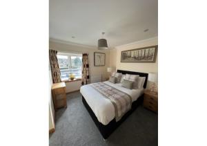 a bedroom with a bed and a window at The Waverley Inn Holiday Homes in Inverness