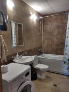 a bathroom with a sink and a toilet and a tub at Kolimechkov Apartments Borovets in Borovets