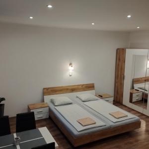 a bedroom with a large bed and a mirror at Apartmány 77 in Veľký Meder +75 photos