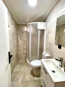 a bathroom with a shower and a toilet and a sink at Mustafa Tokalaç Castle house in Marmaris