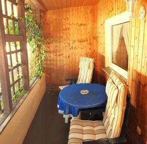 a table and two chairs on a porch at Villa Helvetia in Bad Elster