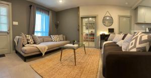 a living room with two couches and a table at Downtown Views, Rooftop Deck, Pets in Dallas