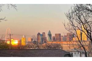 a view of a city skyline with the sun setting at Downtown Views, Rooftop Deck, Pets in Dallas +24 photos