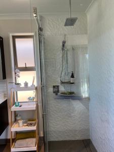 a bathroom with a shower and a sink at Ra-ata Farm in Rangiora