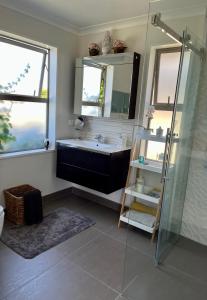 a bathroom with a tub and a sink and a shower at Ra-ata Farm in Rangiora