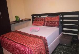 A bed or beds in a room at Palmeiras Guest House Matola