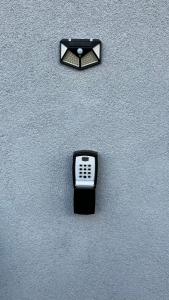 a cell phone on the side of a wall at Nathallie Modern Apartments in Timişoara