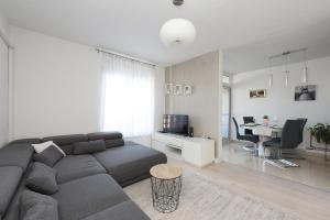 - un salon avec un canapé gris et une table dans l'établissement Apartment Teodora, à Zadar