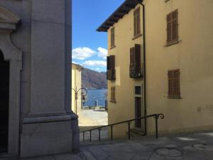 a view of a body of water from between two buildings at Casa Terrazzo Panoramico in Cannobio