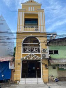 a yellow building with a balcony on top of it at ROMY'S PLACE - ENTIRE 3RD FLOOR APARTMENT in Vigan